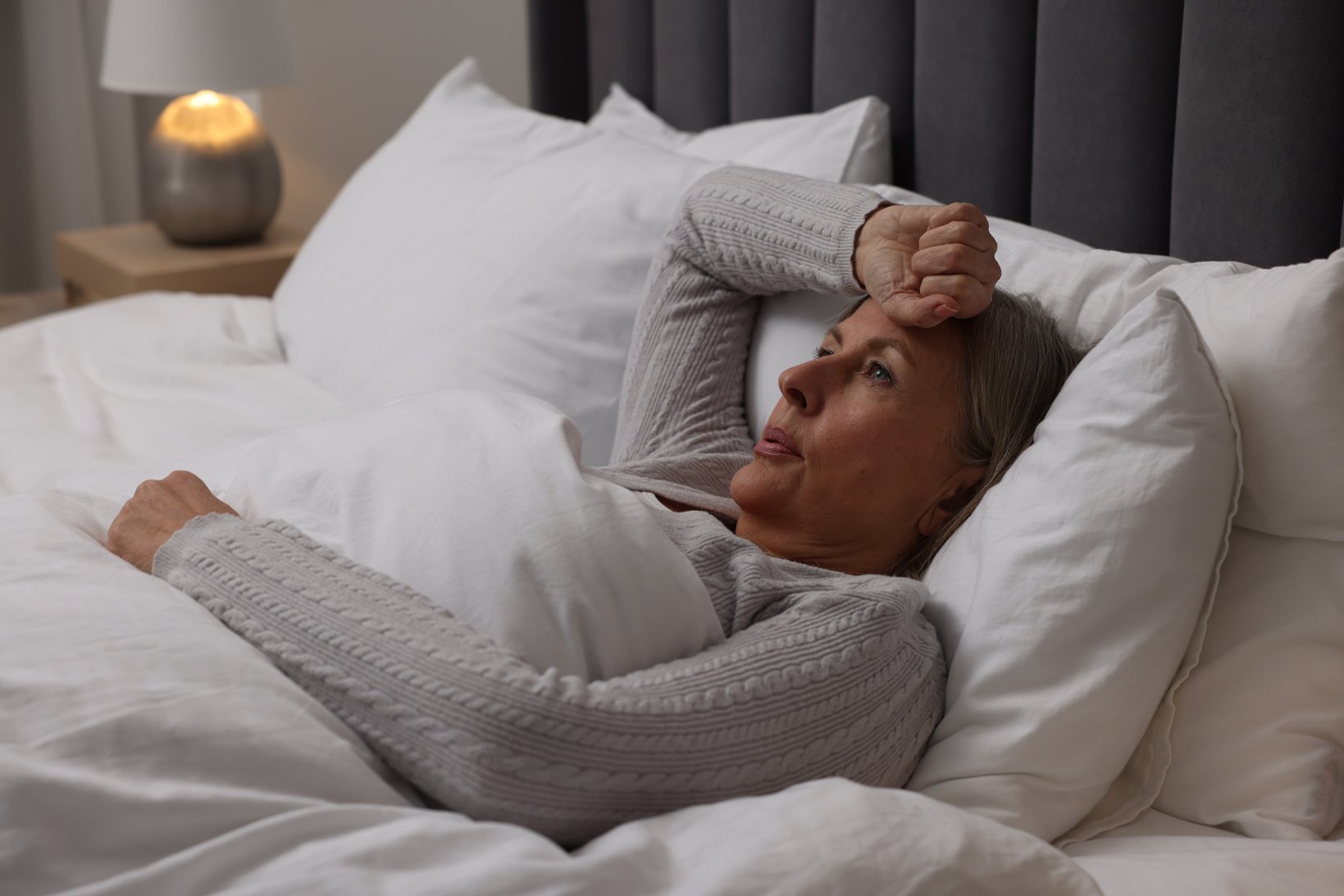 Menopause, Night Sweat. Woman Suffering from Hot Flash in Bed